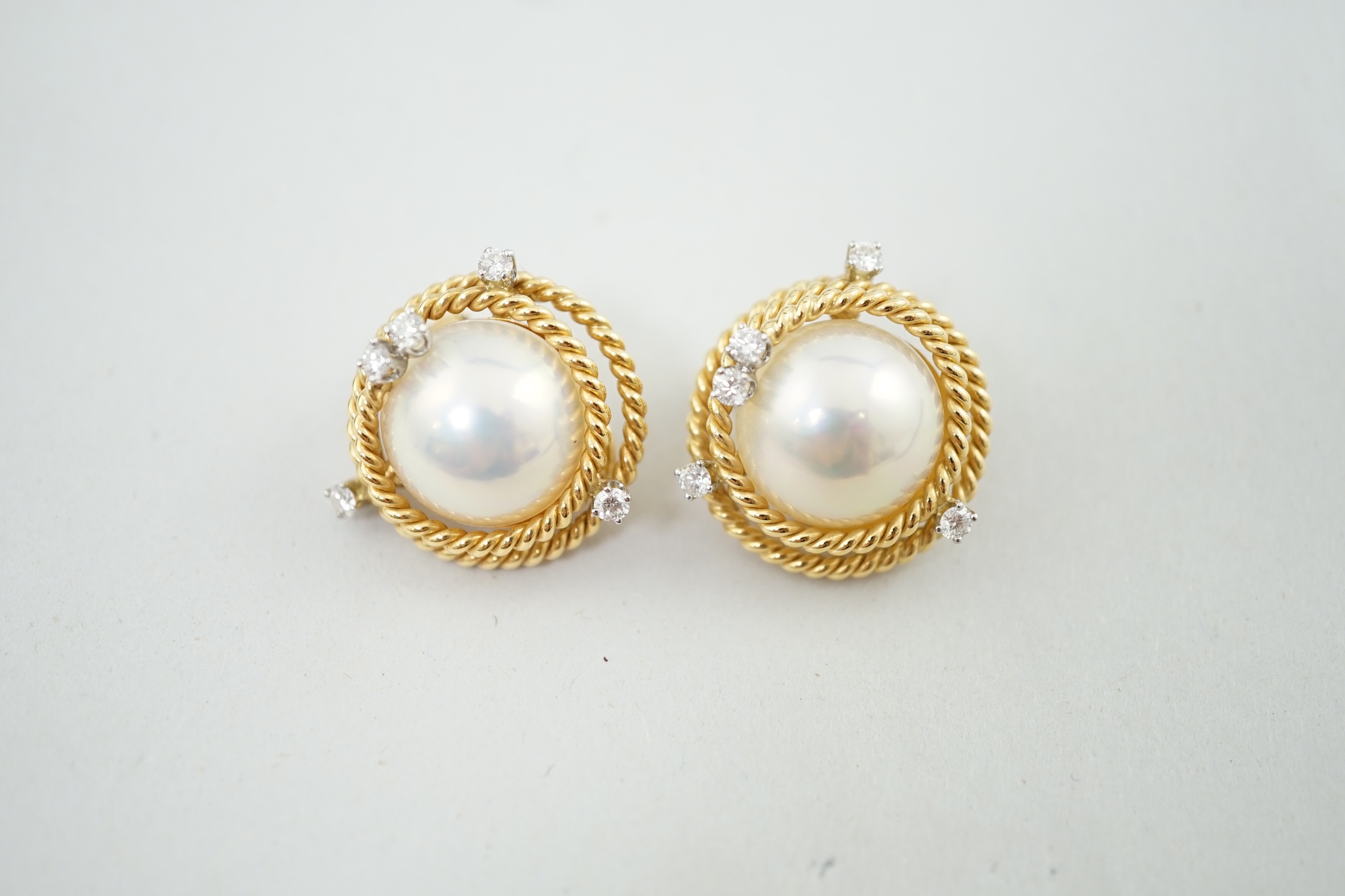 A modern pair of Tiffany & Co Schlumberger Studios 18k gold, mabe pearl and five stone diamond set ear clips